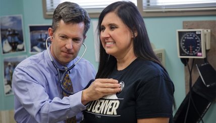 Dr Beuther listening to a patients heart