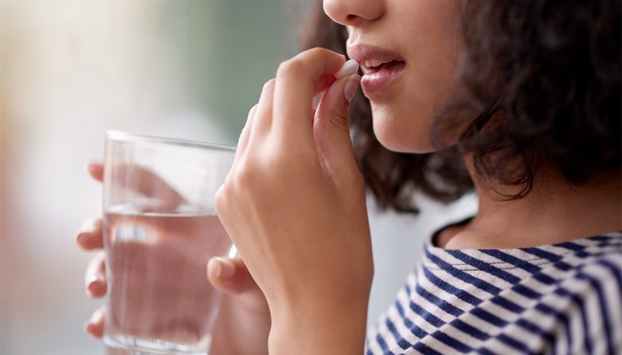 woman taking pill