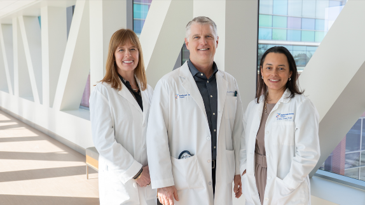 Three doctors standing in a breezeway