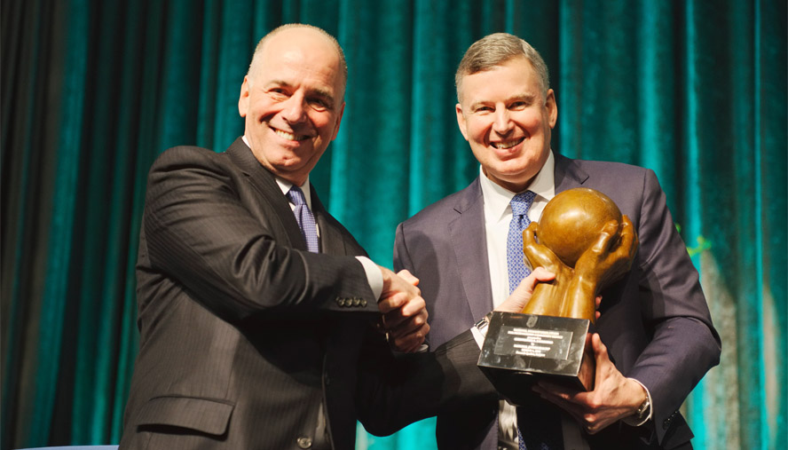 Dinner Chair Patrick L. Bickers (left) presents Honoree Chris Carmosino with the National Jewish Health Humanitarian Award.