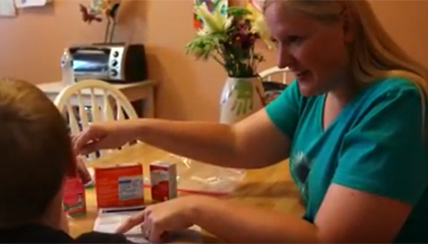 Parent showing child their medications