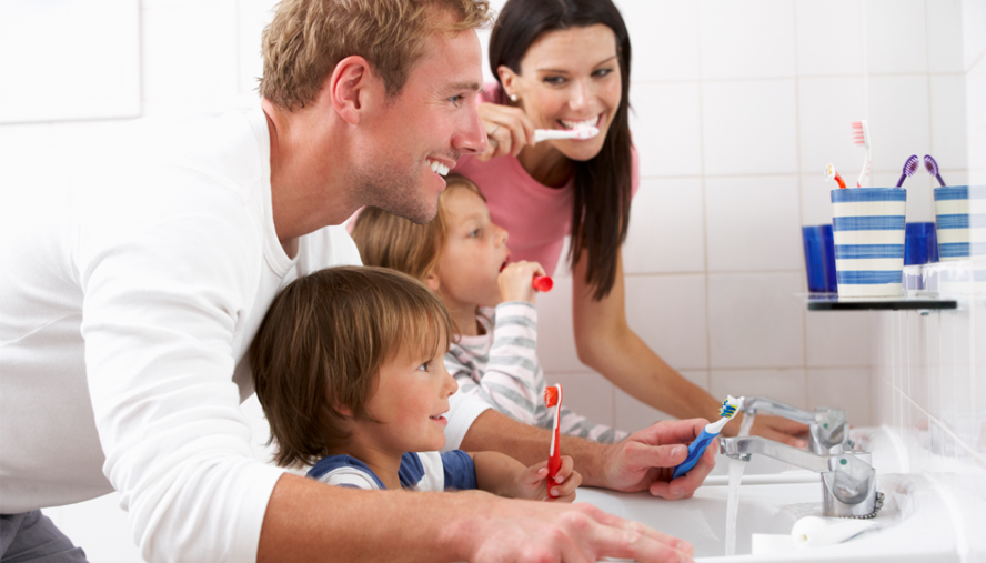 Family brushing teeth as a routine