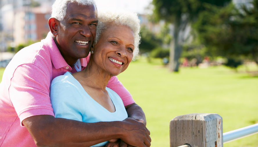 Elderly Black man and woman hugging