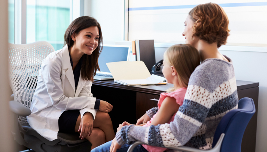 Pediatrician explaining prescription to child and parent