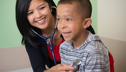 Doctor listening to a childs heart