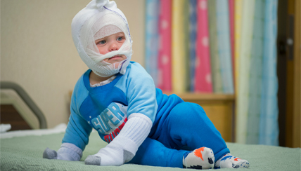 Infant wrapped in moisturizing cloth