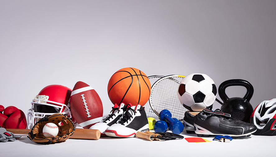 Basketballs, footballs, baseball bat, kettlebell, soccer cleats, and other sports equipment.