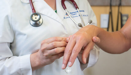 Physician treating patient's hand Physician treating patient's hand