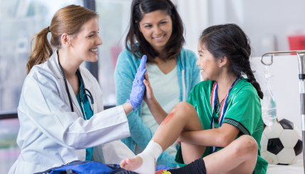 Doctor giving young patient a high five