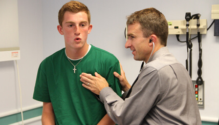 physician listening to lungs of pediatric patient