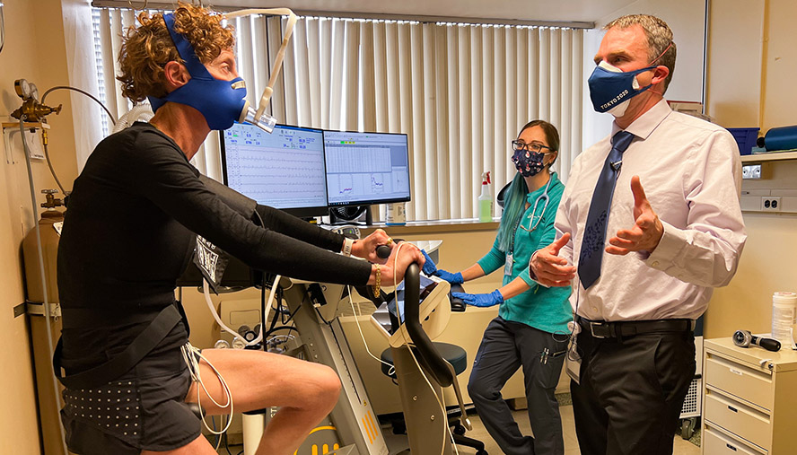 Patient on exercise bike performing evaluation tests